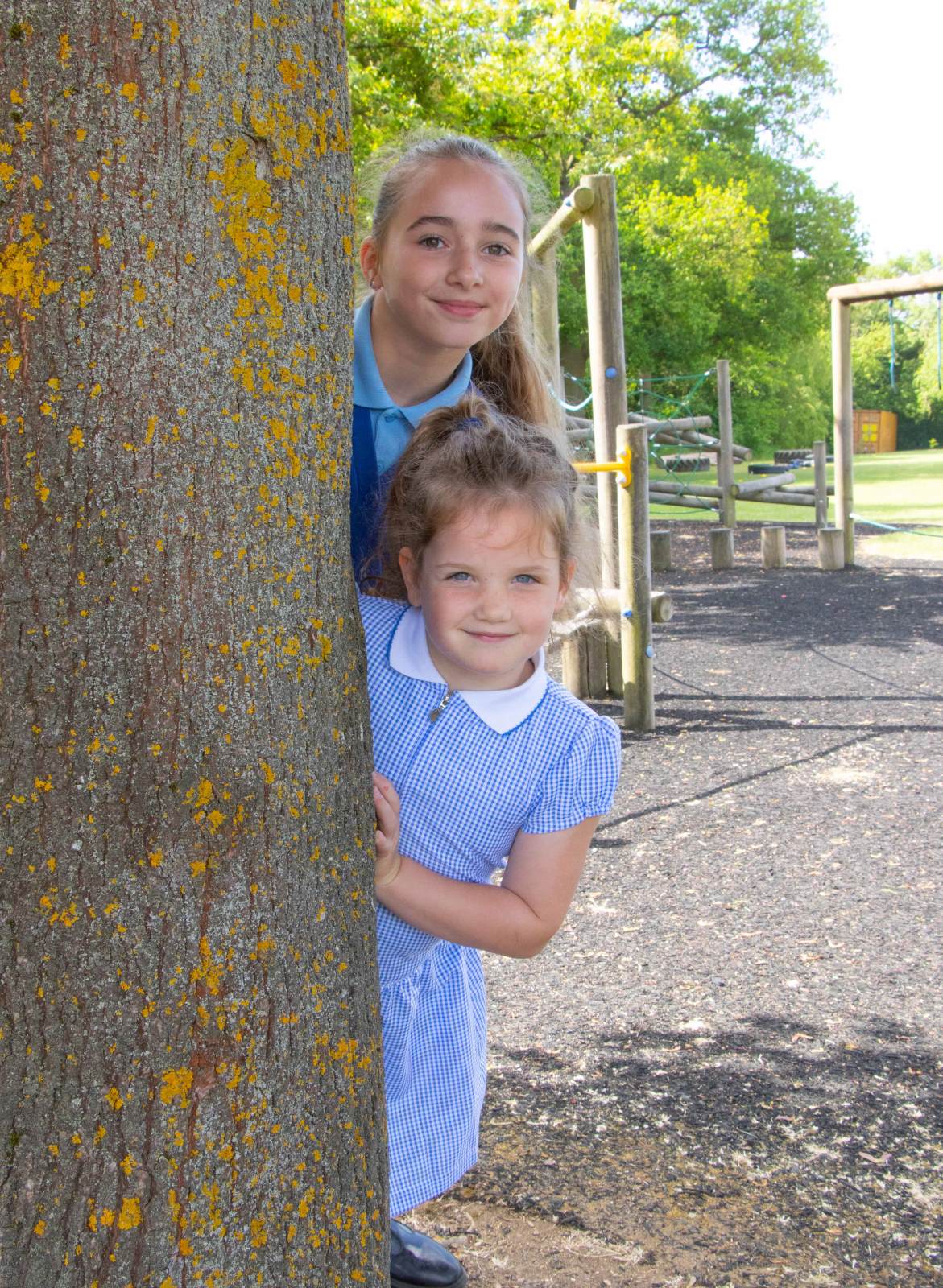 Pupils hiding by a tree Pupils hiding by a tree